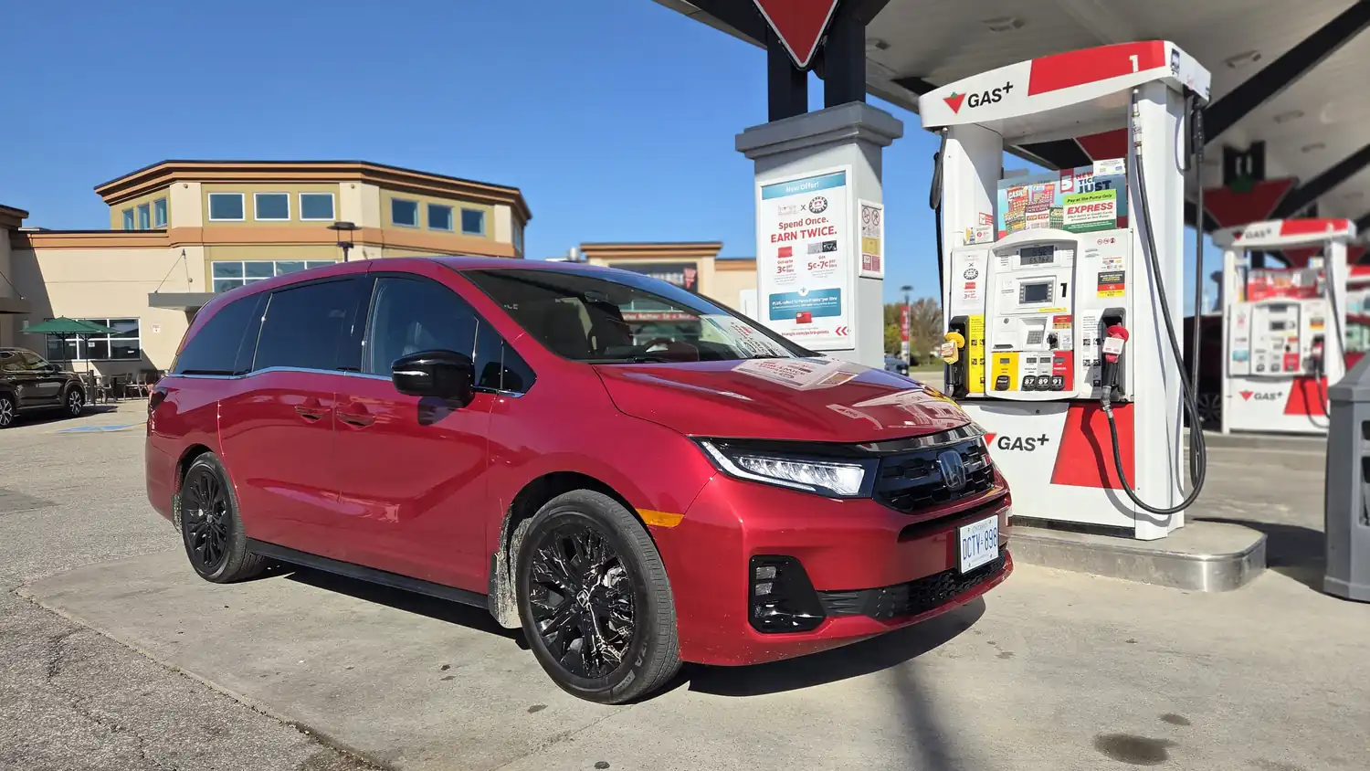 Red Honda Odyssey at a gas station during a fuel economy test